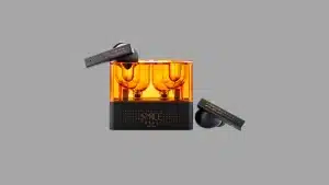 Moondrop Space Travel wireless earbuds with black stems placed beside an orange transparent charging case