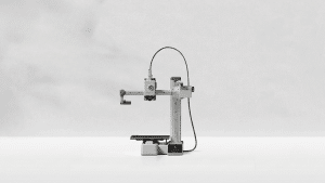 Bambu Lab A1 Mini 3D printer placed on a clean white surface with a minimalist background.