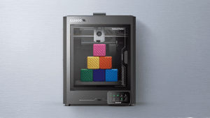 ELEGOO Centauri Carbon 3D printer with colorful cube models inside the enclosed build chamber.