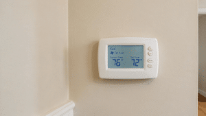 Wall thermostat set to Cool mode with the fan on Auto and a lower target temperature.