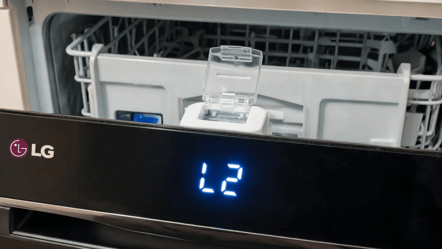 Open LG dishwasher rack area showing L2 display code