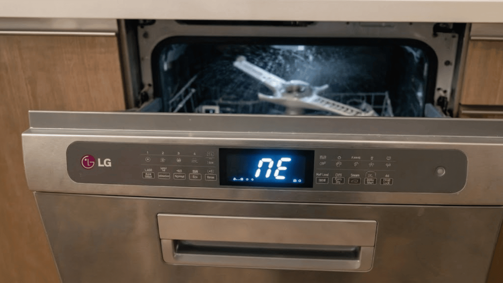 Open LG dishwasher showing NE error code on the digital display